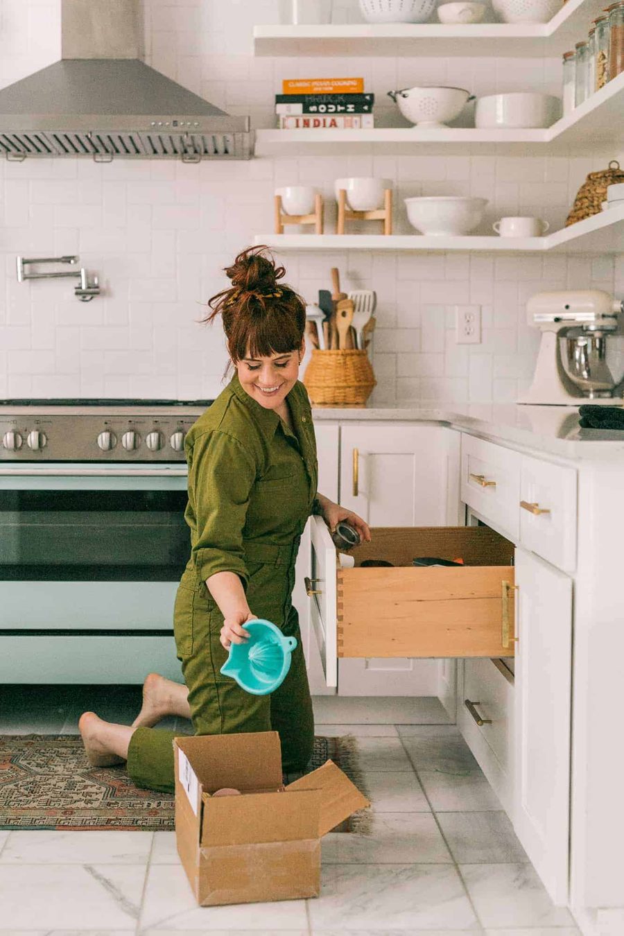 Unpacking a moving box into a bright, organized kitchen