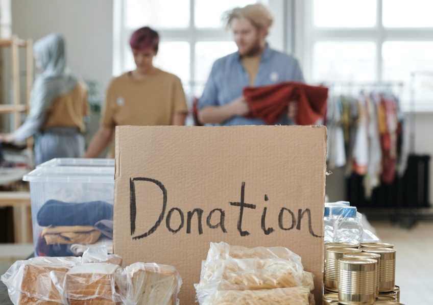 Donation box with sorted clothing and food at a local charity