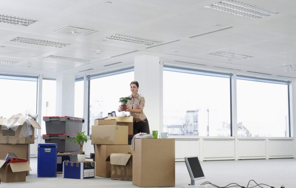 Unpacking boxes in a bright, empty office during a move